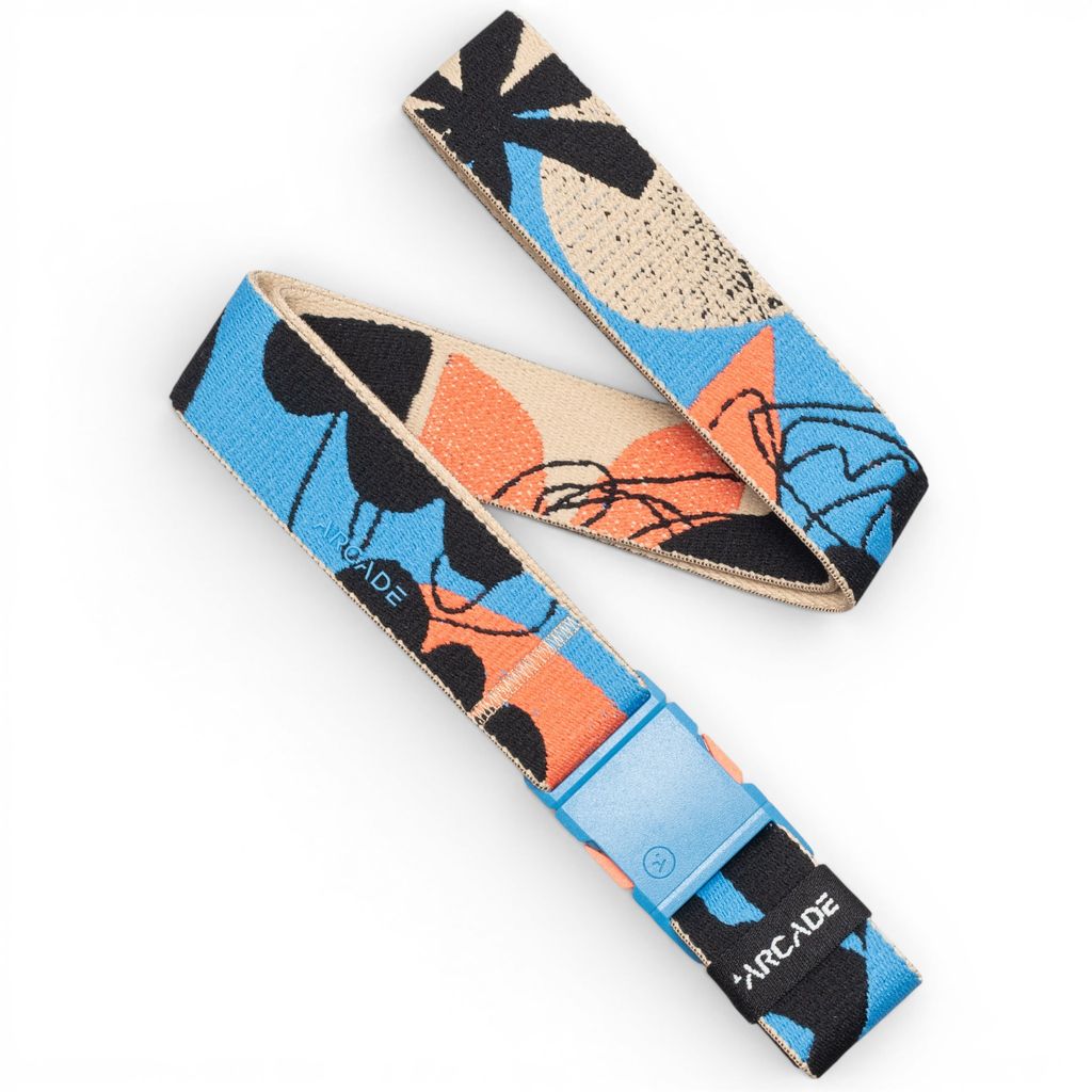 A belt with a colorful abstract pattern in blue, orange, black, and beige, featuring a light blue quick-release buckle and the brand name 'ARCADE' printed on the strap and buckle.